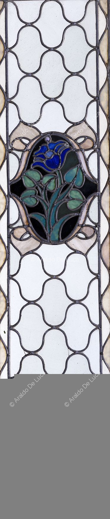 Stained glass window with geometric motif and flower