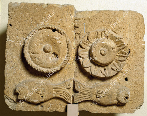 Stone relief with flowers and fish