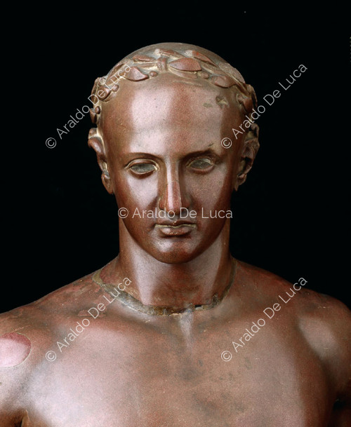 Bust of male figure with laurel wreath