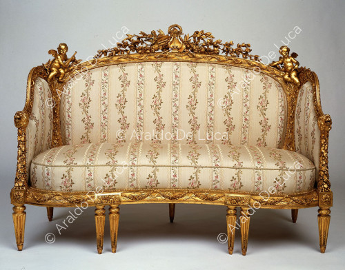 Upholstered gilded armchair