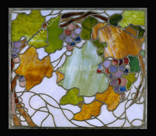 Stained glass window with leaves and grapes